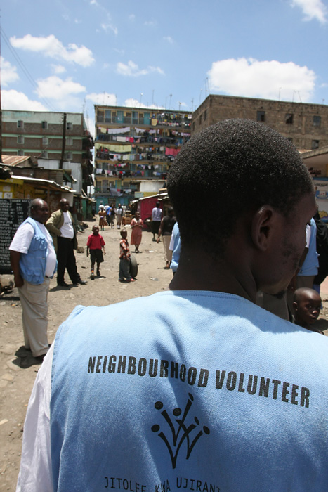 A neighborhood volunteer walks through Mathare Slum in Nairobi, Kenya.