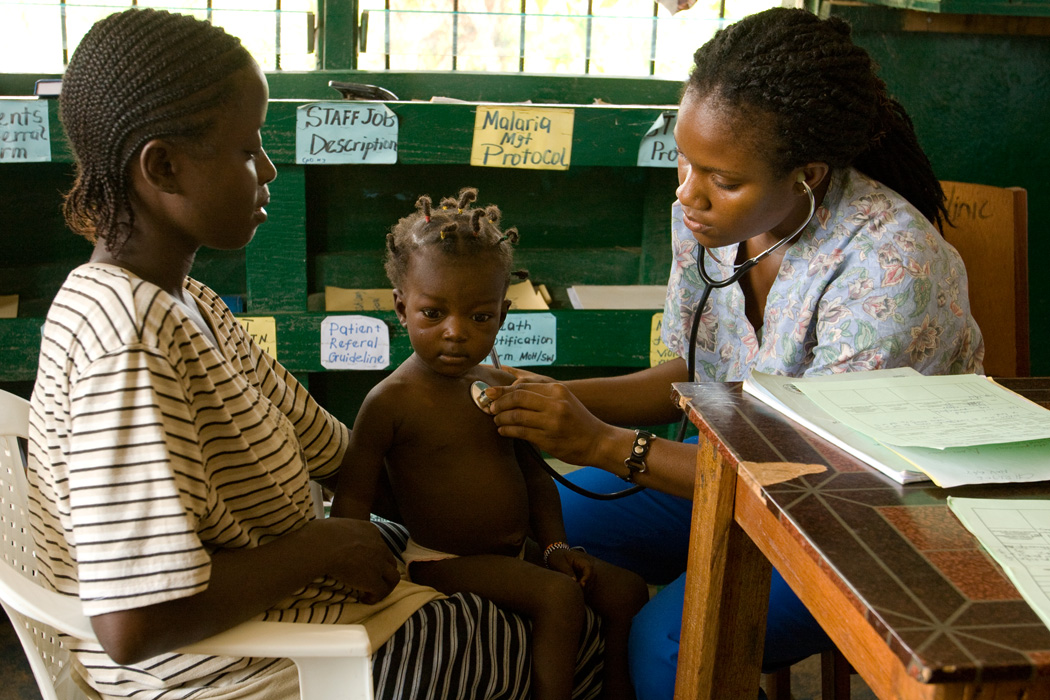 A local UN Volunteer nurse examines a patient in Grand Bassa County, Liberia.