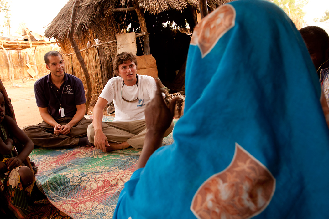 Two UN Volunteers speak to residents of the Djabal Refugee Camp in Goz Beida, Chad.