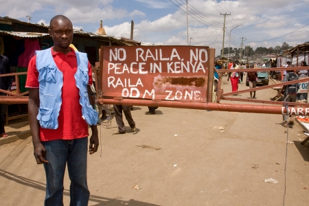 A volunteer stands at a gate he guarded during the ethnic violence after Kenya's elections 2007.
