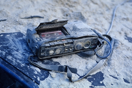 A professional tape recorder on the hood of a car, probably abandoned by a radio reporter when the first building collapsed