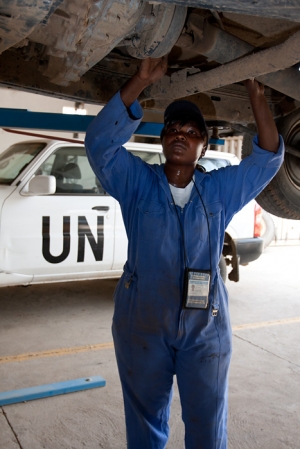 A UN volunteer car mechanic works on a vehicle at a repair shop in N'Djamena, Chad