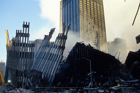 A section of the outer façade of the World Trade Center tower (left) has ripped off a section of WTC 4 (right) as it fell.